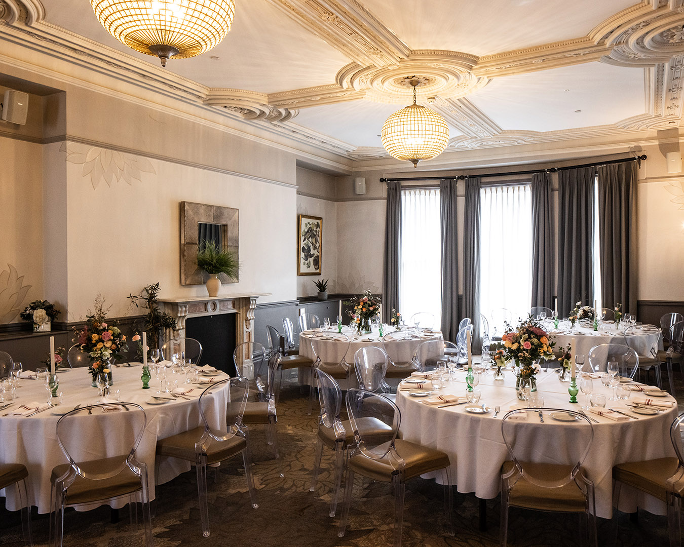 A beautiful private room with elegant Victorian ceiling mouldings, decorated and set for a private event