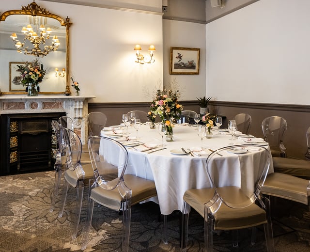 A large dining table in an elegant Victorian-style private room