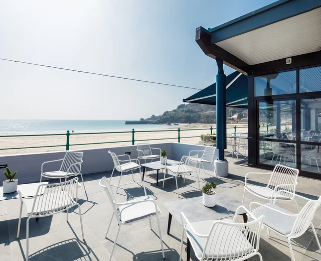 The terrace at Oyster Box featuring stylish outdoor seating on a sunny day
