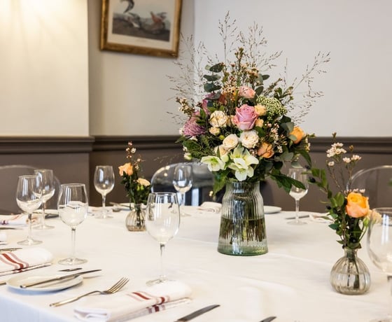 A large dining table in an elegant Victorian-style private room