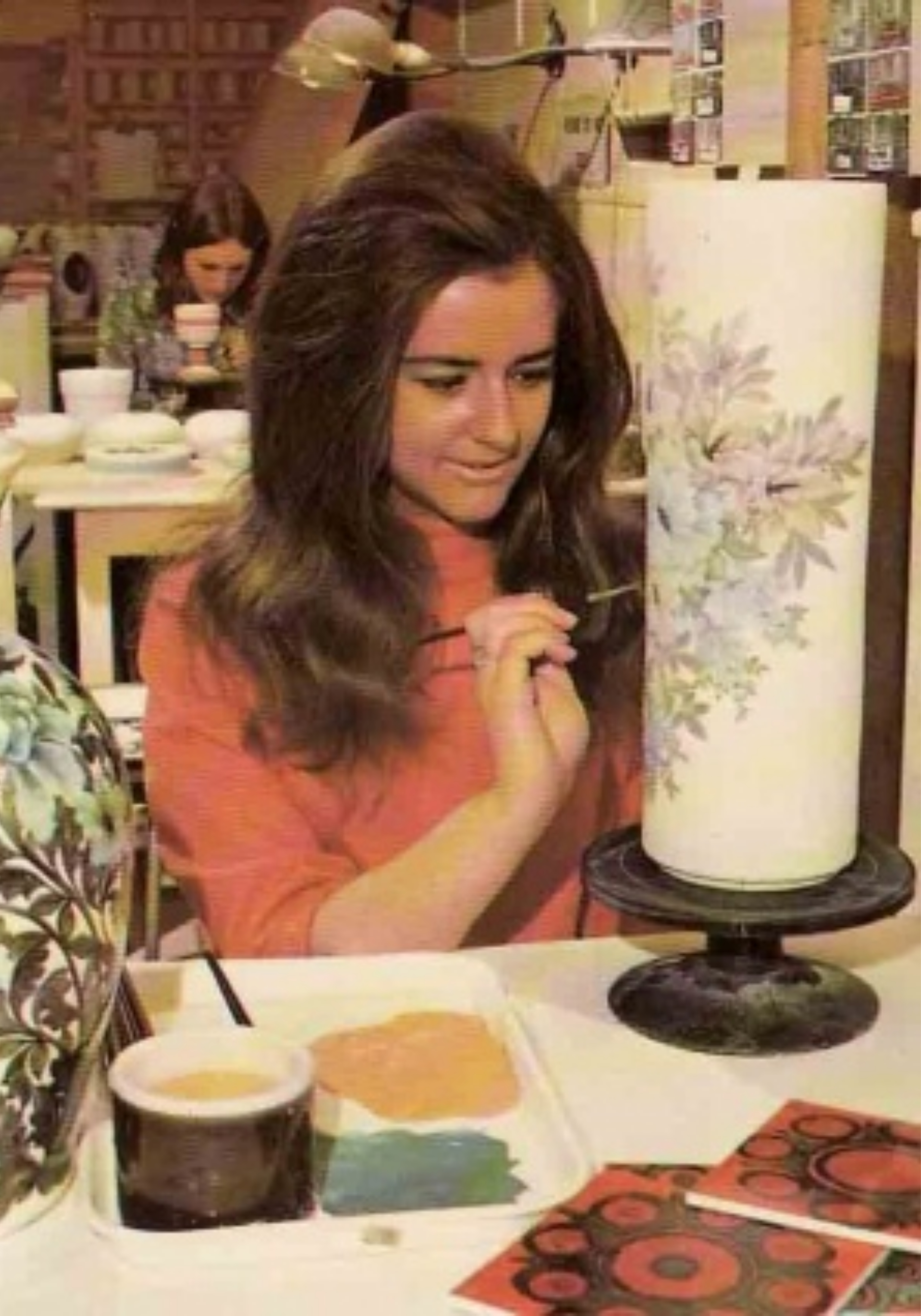 A young lady paints a vase at Jersey Pottery in the 1970s