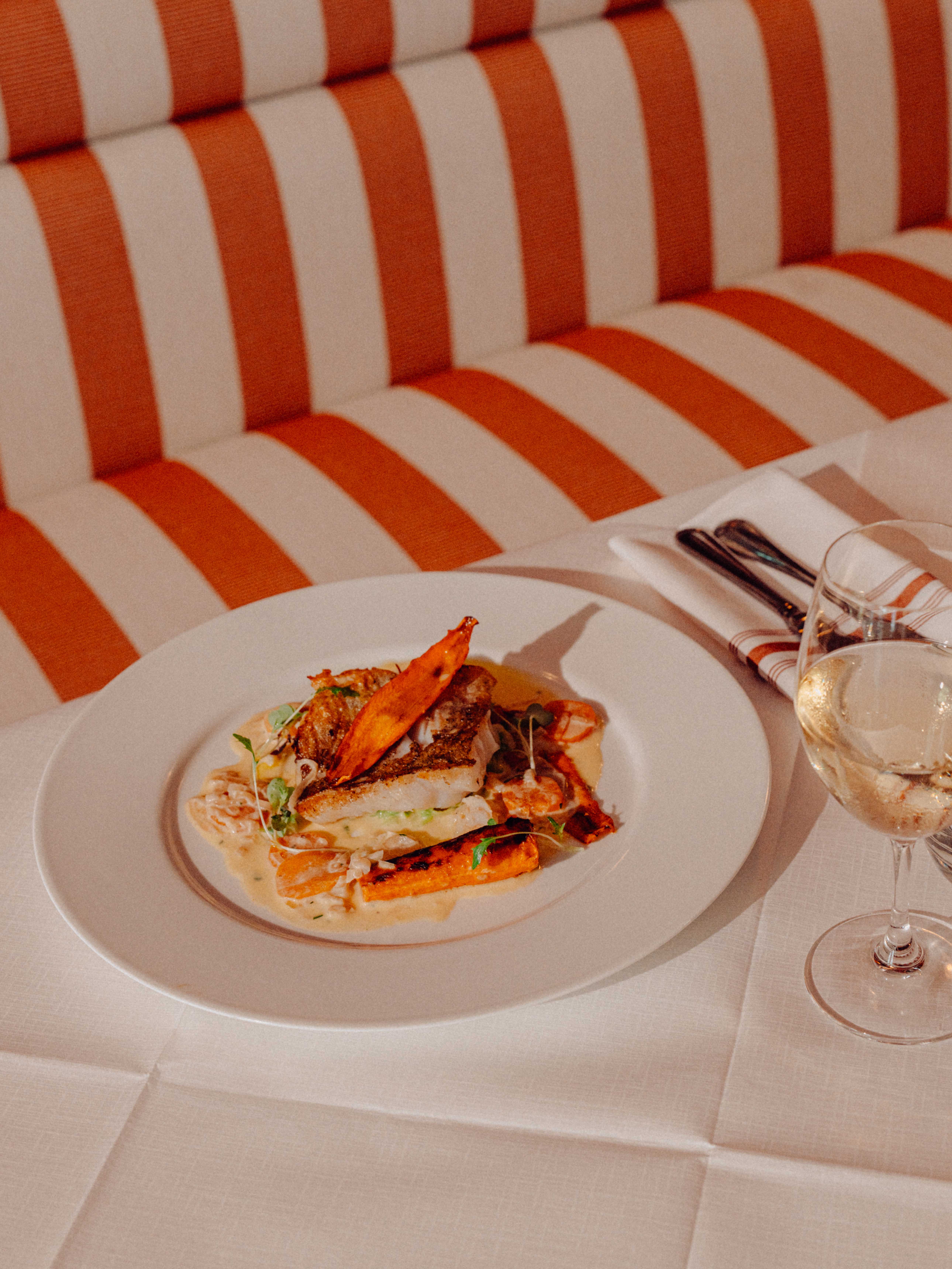 A seafood dish presented on an upscale dining table