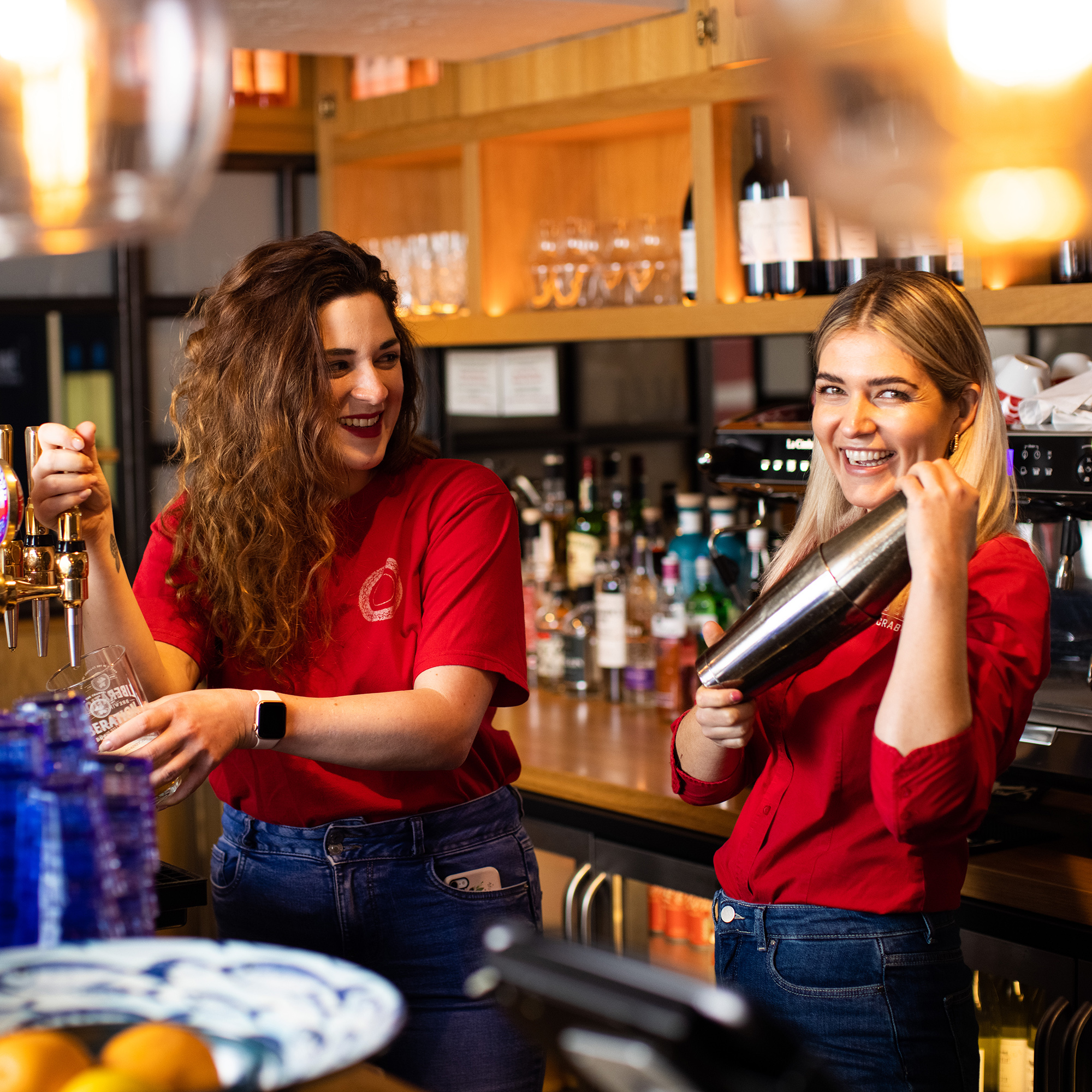 Two team members make drinks happily at Jersey Crab Shack