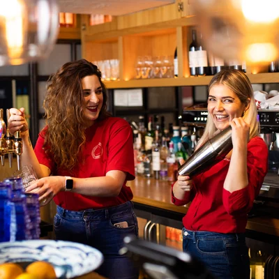 Two team members make drinks happily at Jersey Crab Shack