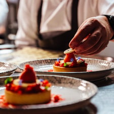 A chef puts the final touch to a dessert