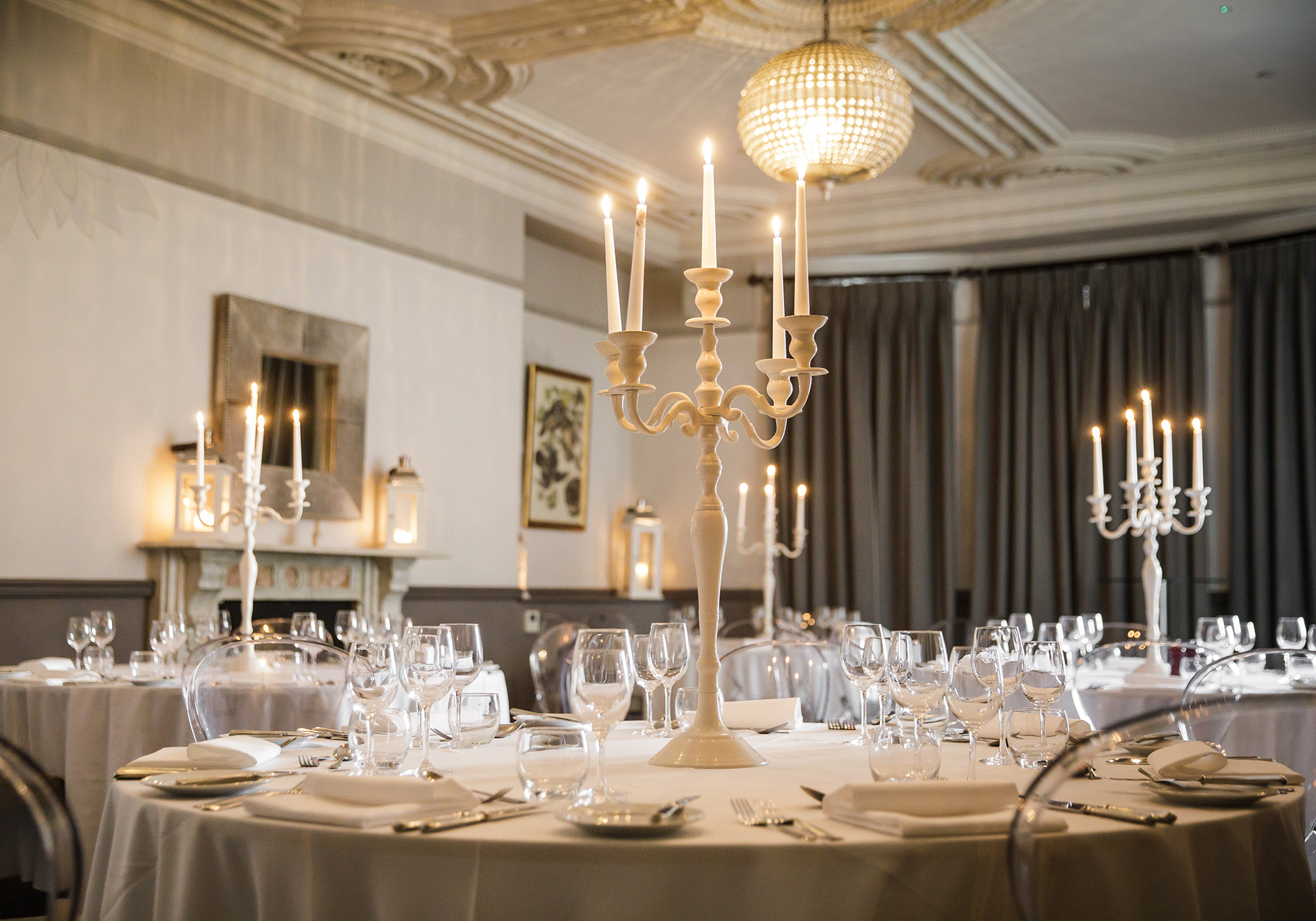 A beautiful private room with elegant Victorian ceiling mouldings, decorated and set for a private event