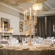 A beautiful private room with elegant Victorian ceiling mouldings, decorated and set for a private event
