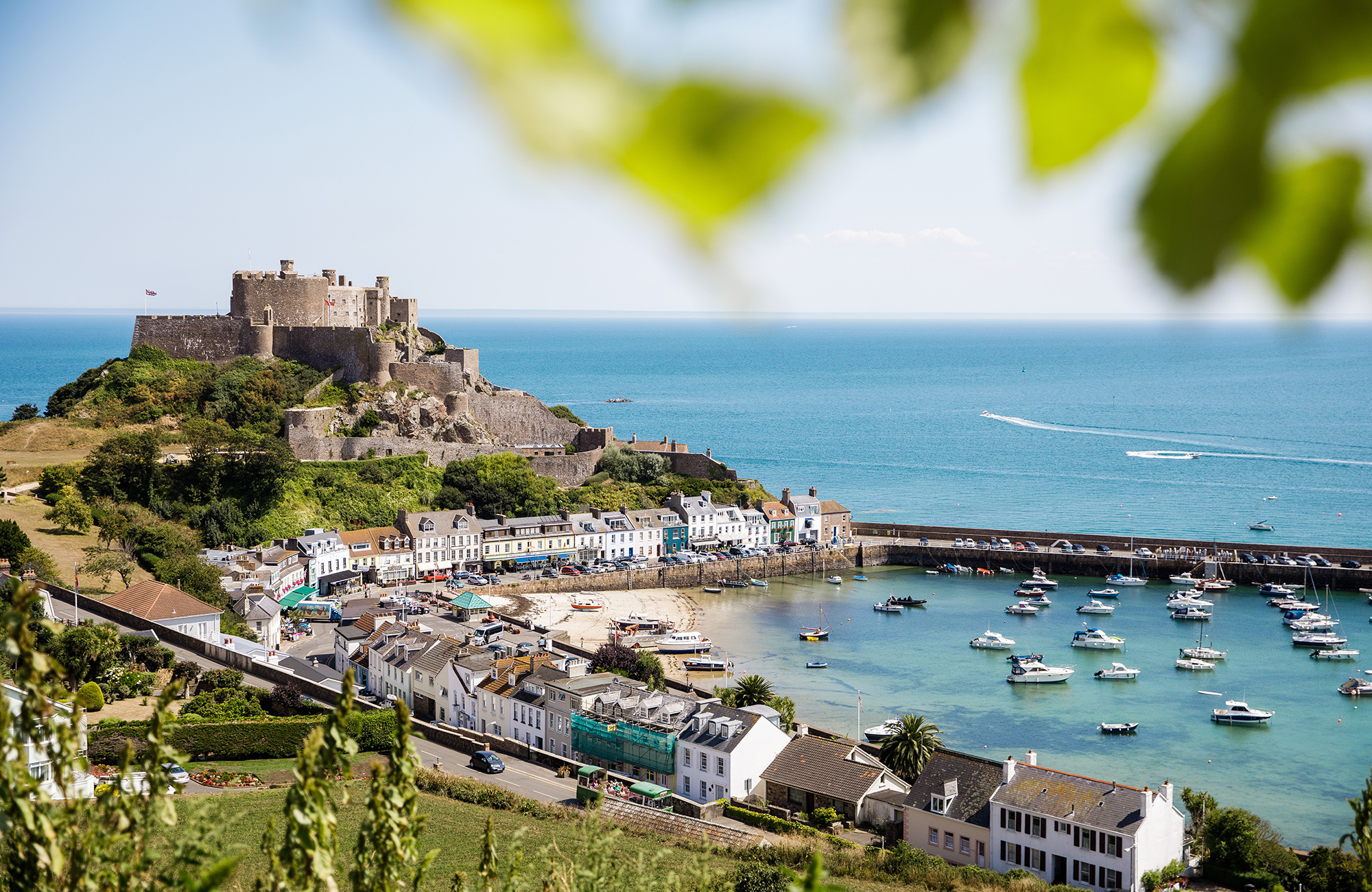 A panoramic view of Mont Orgueil Castle in Gorey, showing the harbour and fields in the foreground