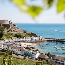 A panoramic view of Mont Orgueil Castle in Gorey, showing the harbour and fields in the foreground