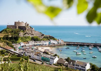 A panoramic view of Mont Orgueil Castle in Gorey, showing the harbour and fields in the foreground