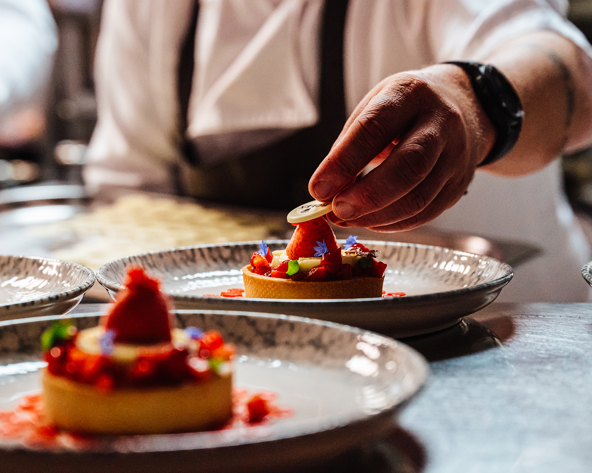 A chef plates an event dessert