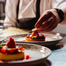 A chef plates an event dessert