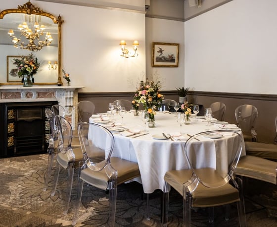 A large dining table in an elegant Victorian-style private room