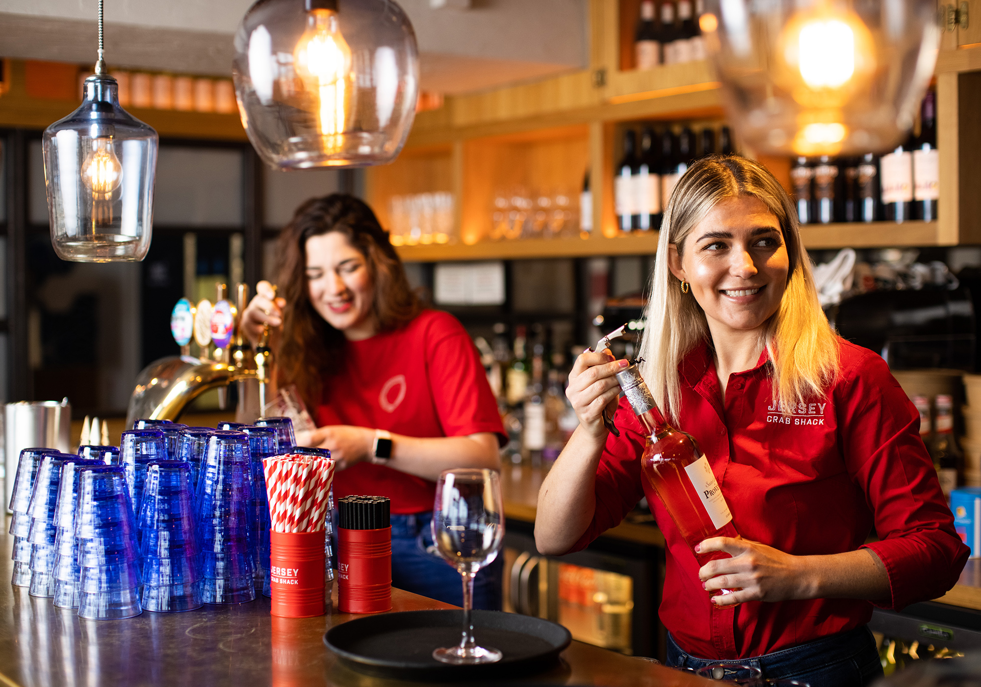 Two team members prepare drinks at Jersey Crab Shack