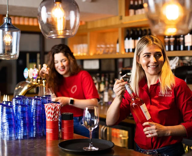 Two team members prepare drinks at Jersey Crab Shack