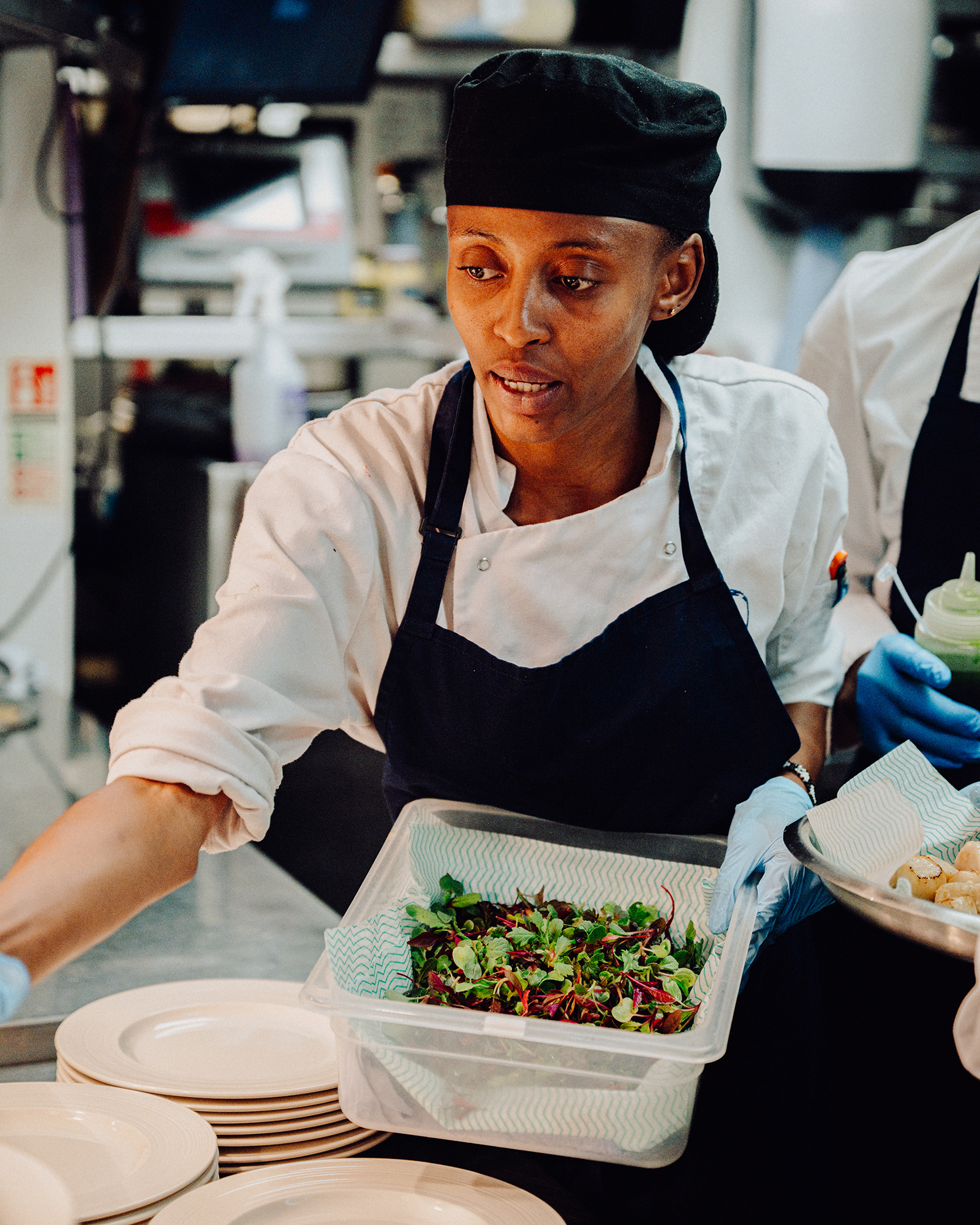 A team member plates salad at Oyster Box