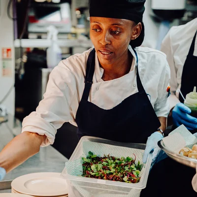 A team member plates salad at Oyster Box