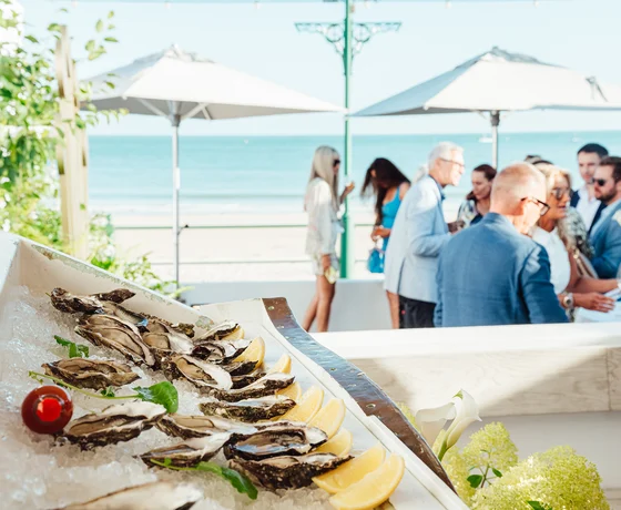 Guests enjoy oysters at a private event on the Oyster Box terrace