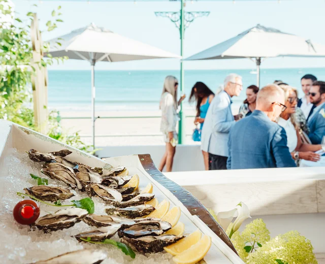 Guests enjoy oysters at a private event on the Oyster Box terrace