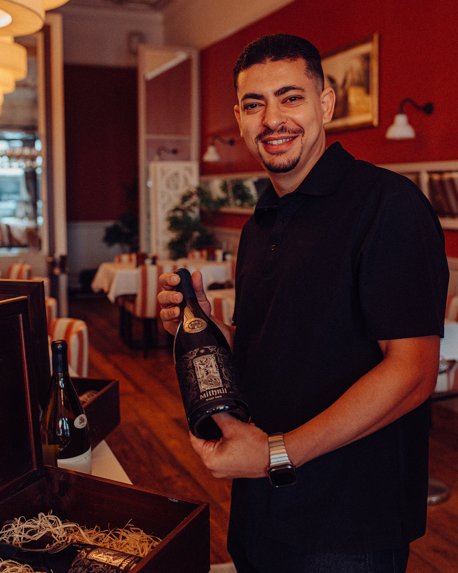 A team member shows a bottle of wine