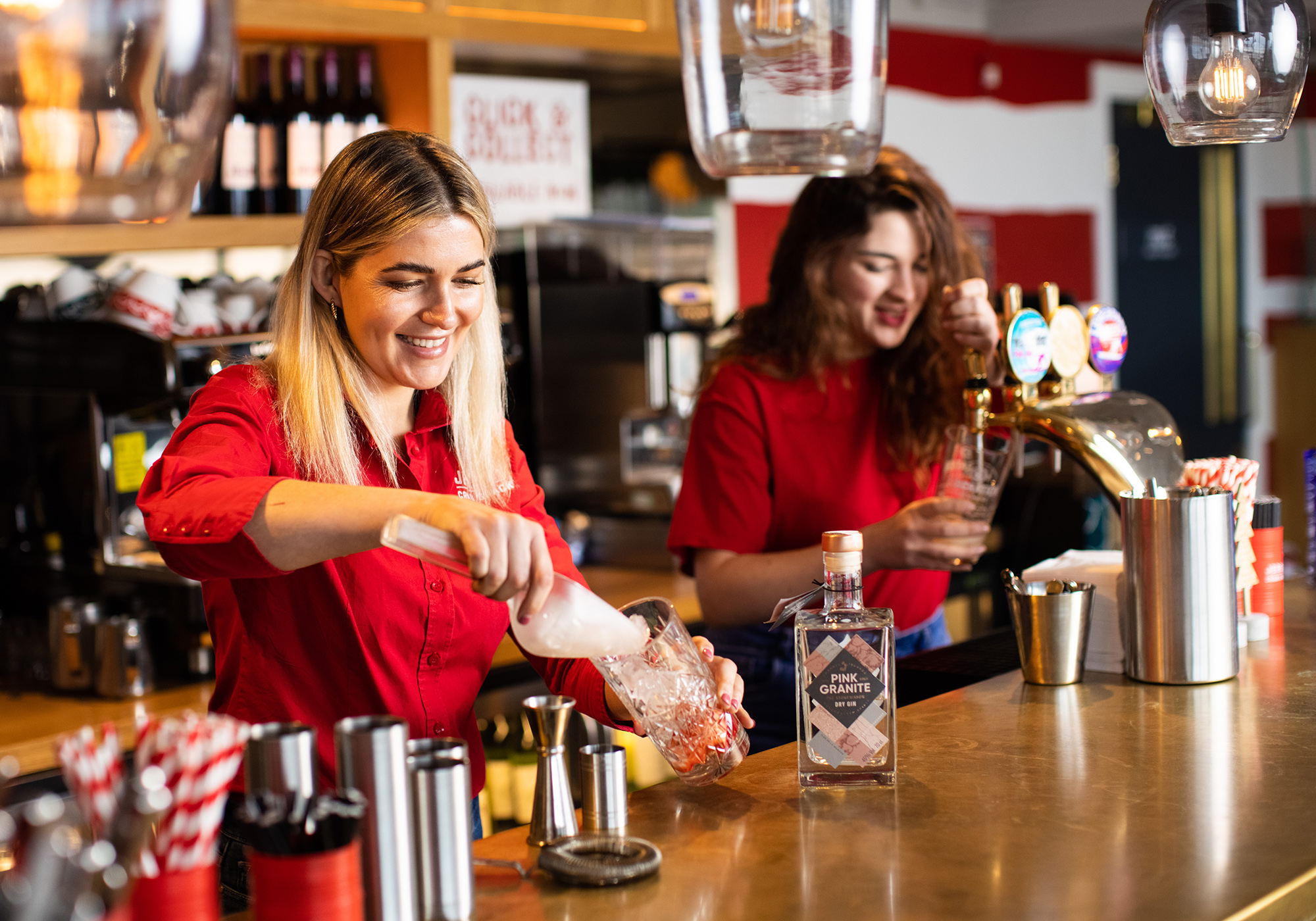 Two women prepare bar drinks at Jersey Crab Shack
