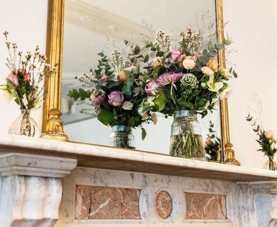 A marble fireplace adorned with floral decorations