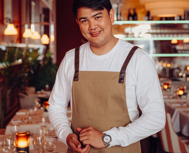 A server stands happily in the Beresford House dining room