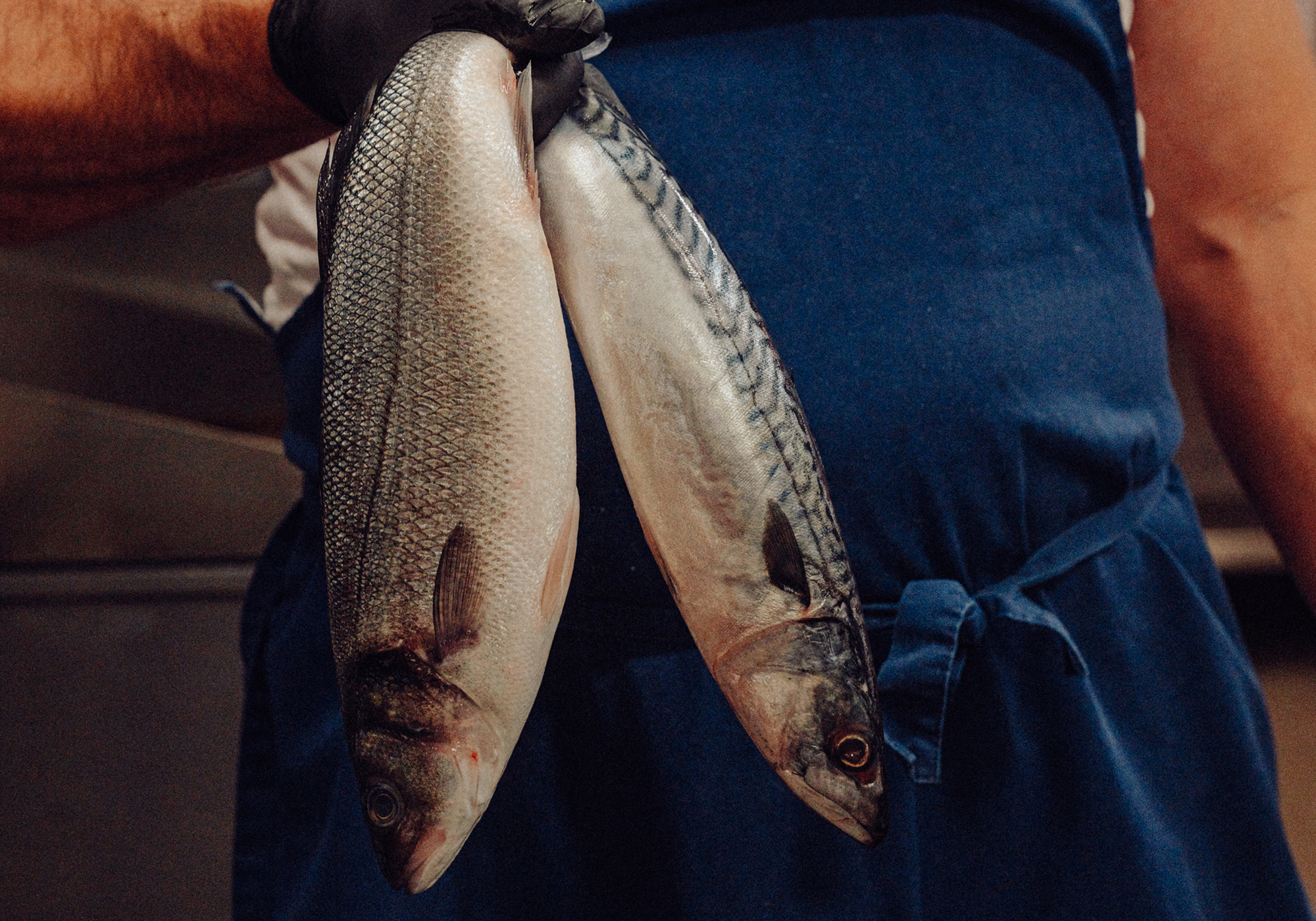 Fresh local fish, held by a JP Restaurants team member