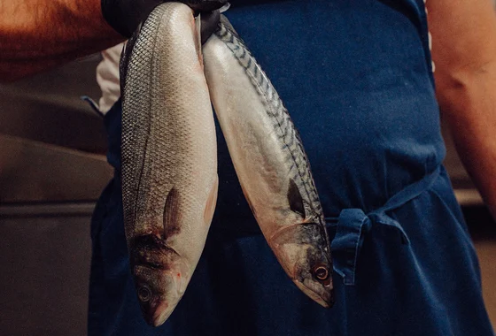 Fresh local fish, held by a JP Restaurants team member