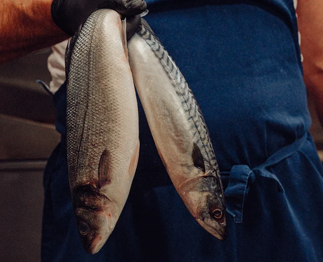 Fresh local fish, held by a JP Restaurants team member