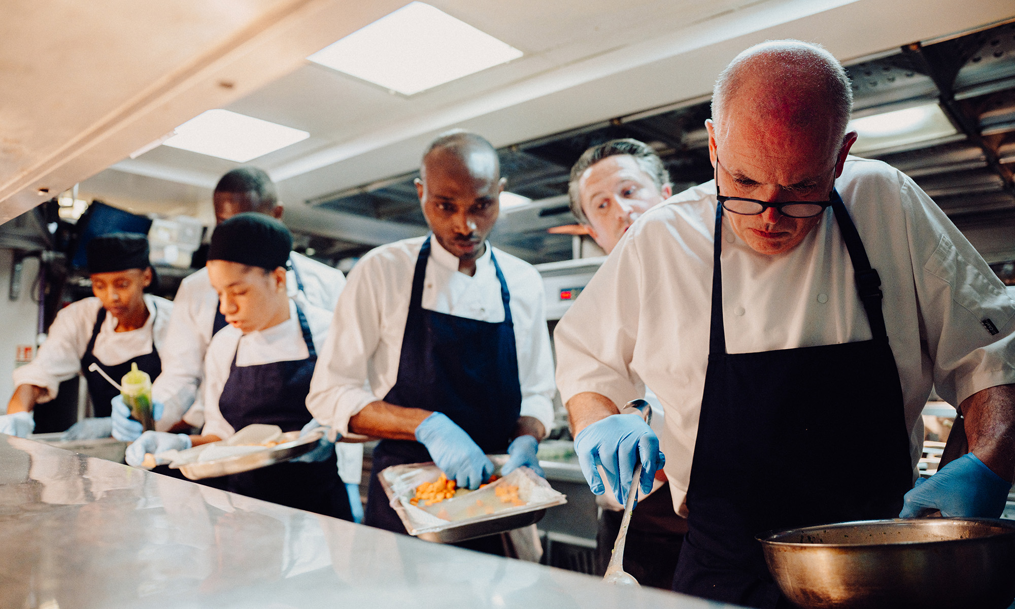 The kitchen team prepare to plate up dishes