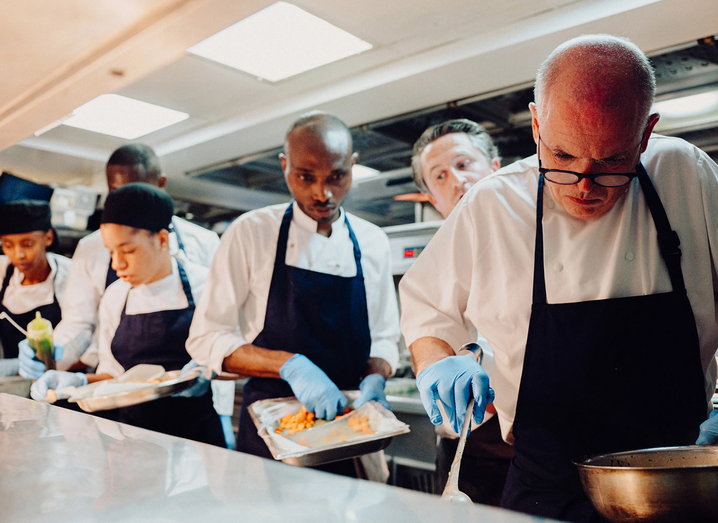 The kitchen team prepare to plate up dishes