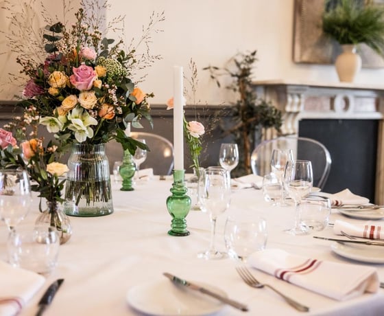 A large dining table in an elegant Victorian-style private room