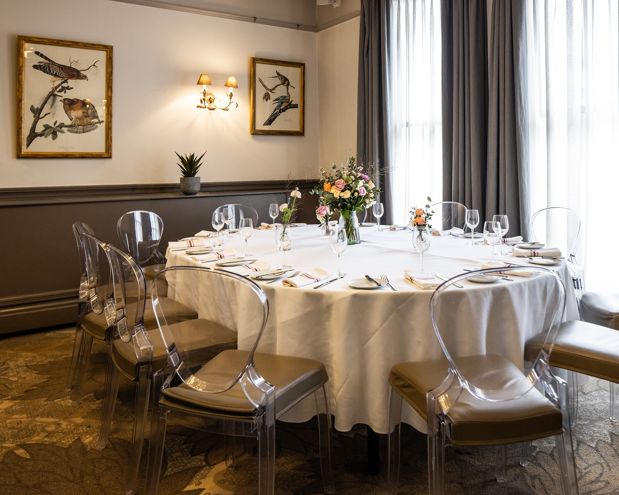 A beautiful private room with elegant Victorian ceiling mouldings, decorated and set for a private event