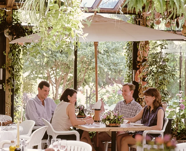 A refined high resolution version of an original 1990s image of guests enjoying lunch at the Jersey Pottery garden restaurant