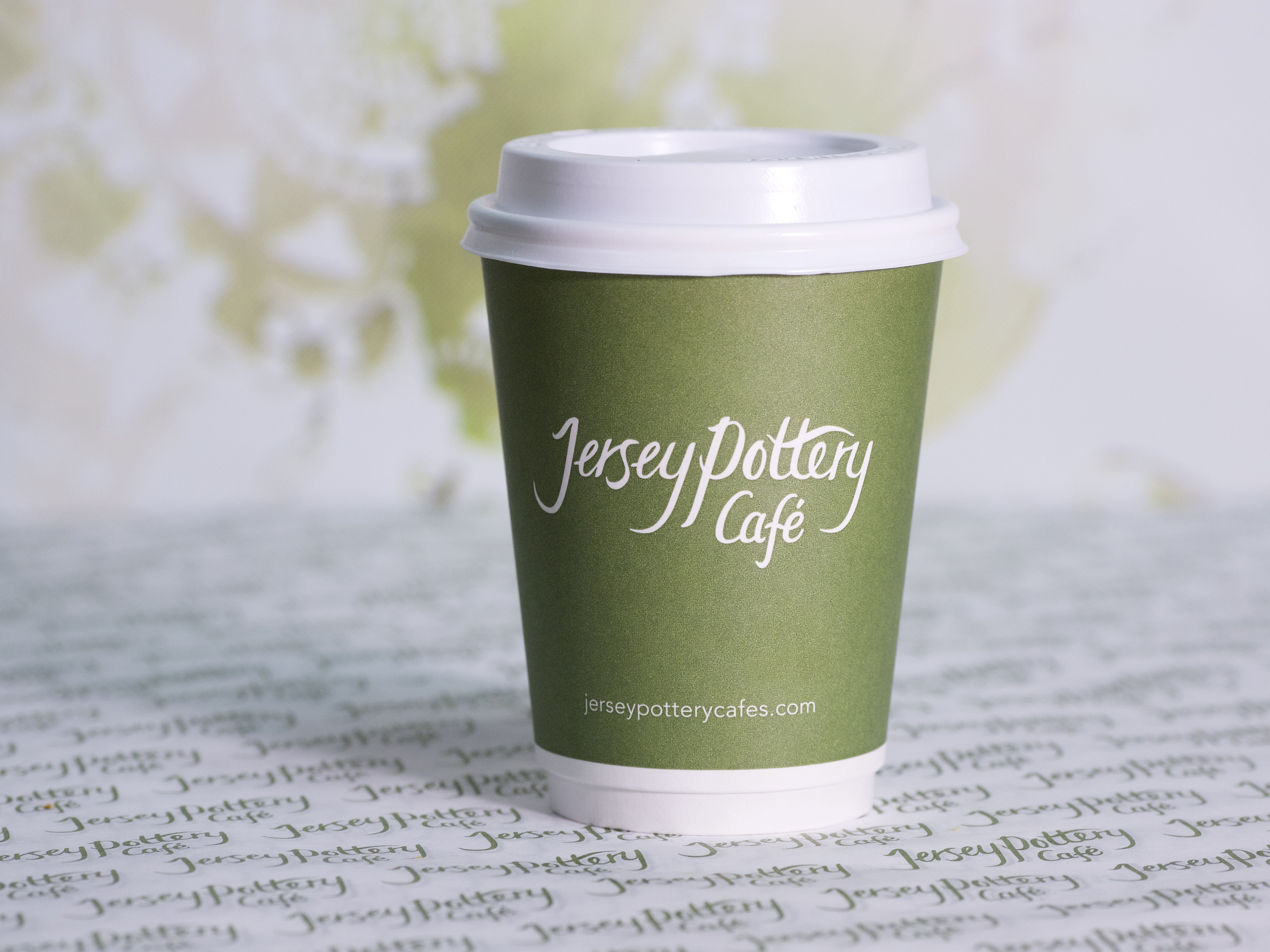 An image of a Jersey Pottery Cafe branded coffee cup, circa 2015