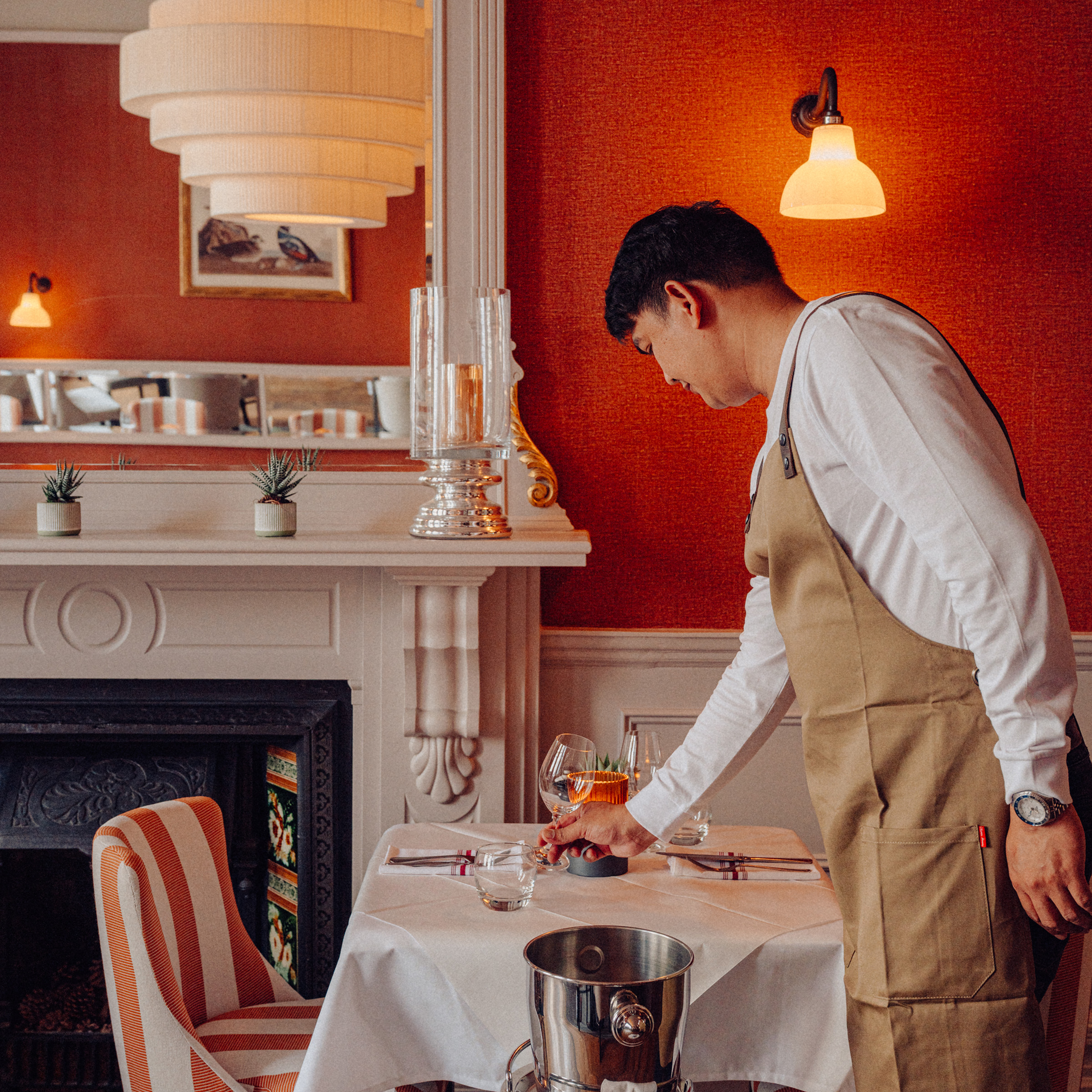 A team member sets a table at Beresford House