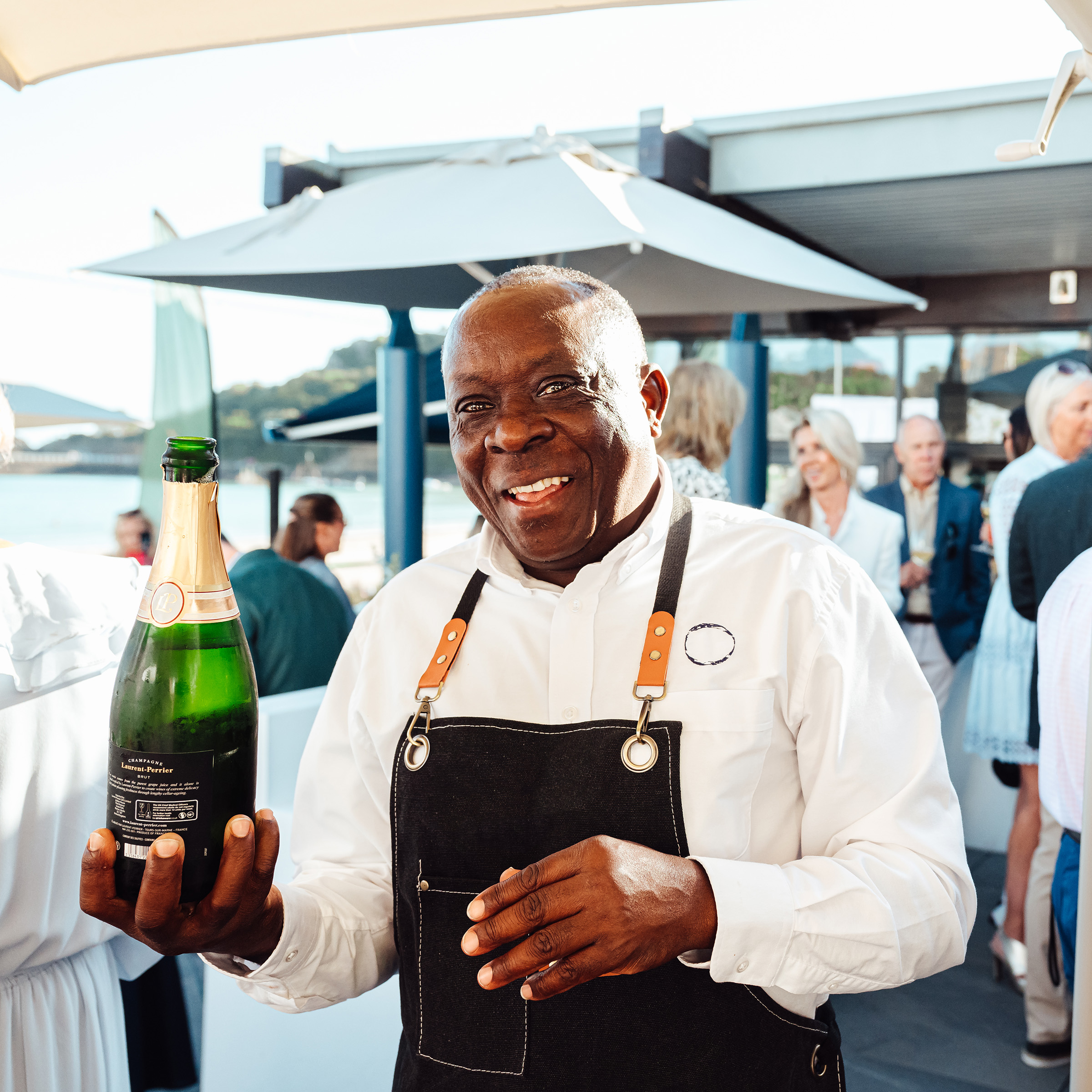 A team member pours champagne at Oyster Box