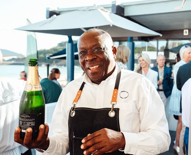 A team member pours champagne at Oyster Box