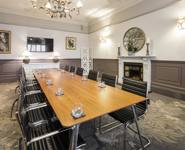 A large boardroom table in a Victorian meeting room