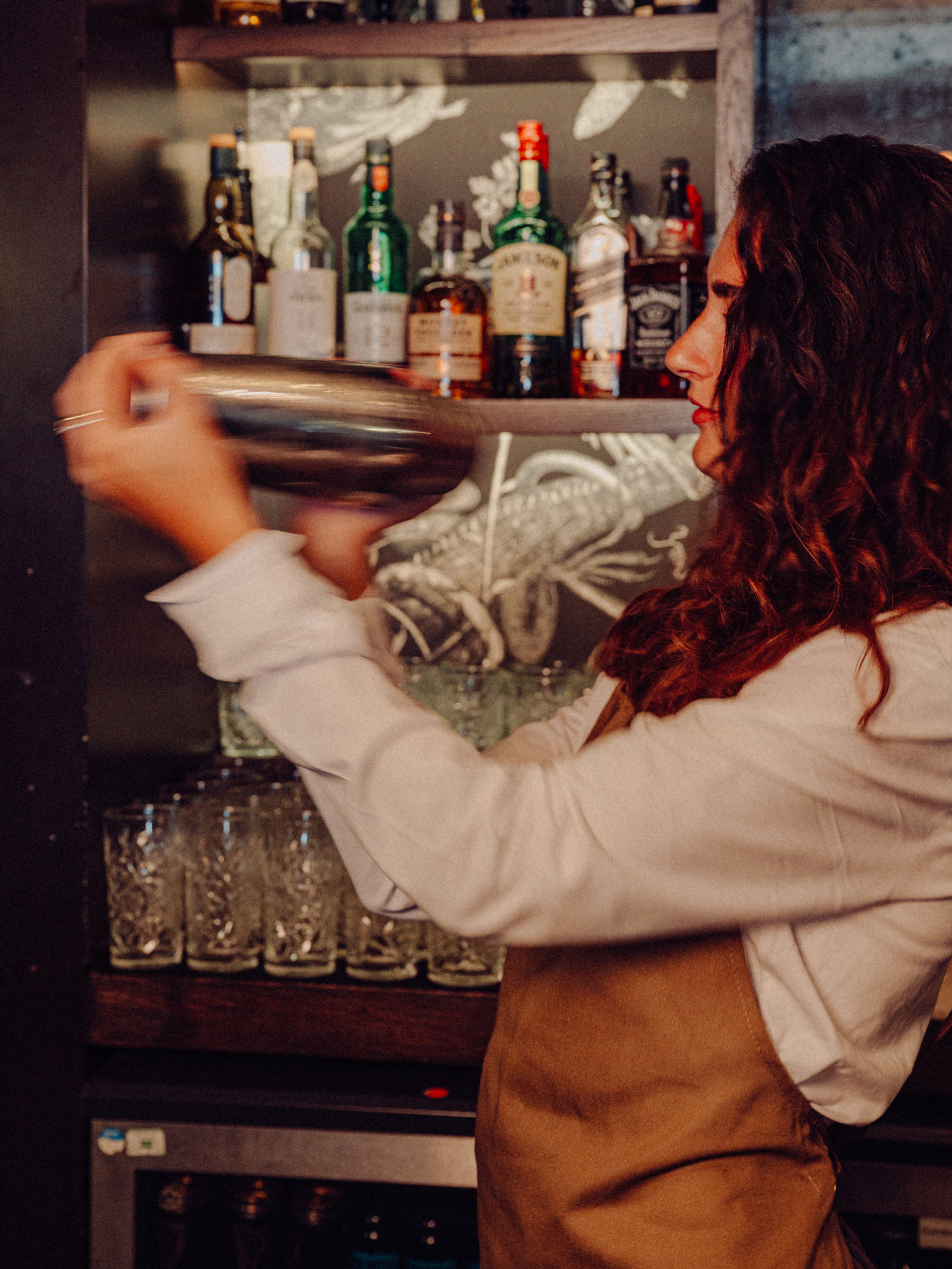 A team member shakes a cocktail at The Old Vic