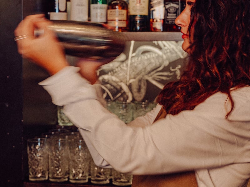 A team member shakes a cocktail at The Old Vic