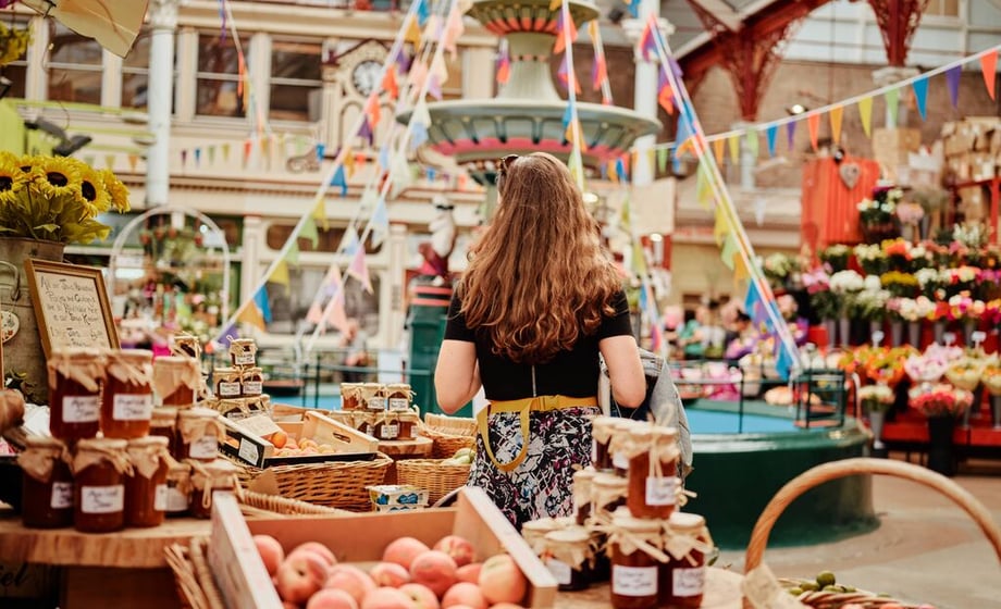 A woman explores the fresh produce stands in St Helier's Central Market