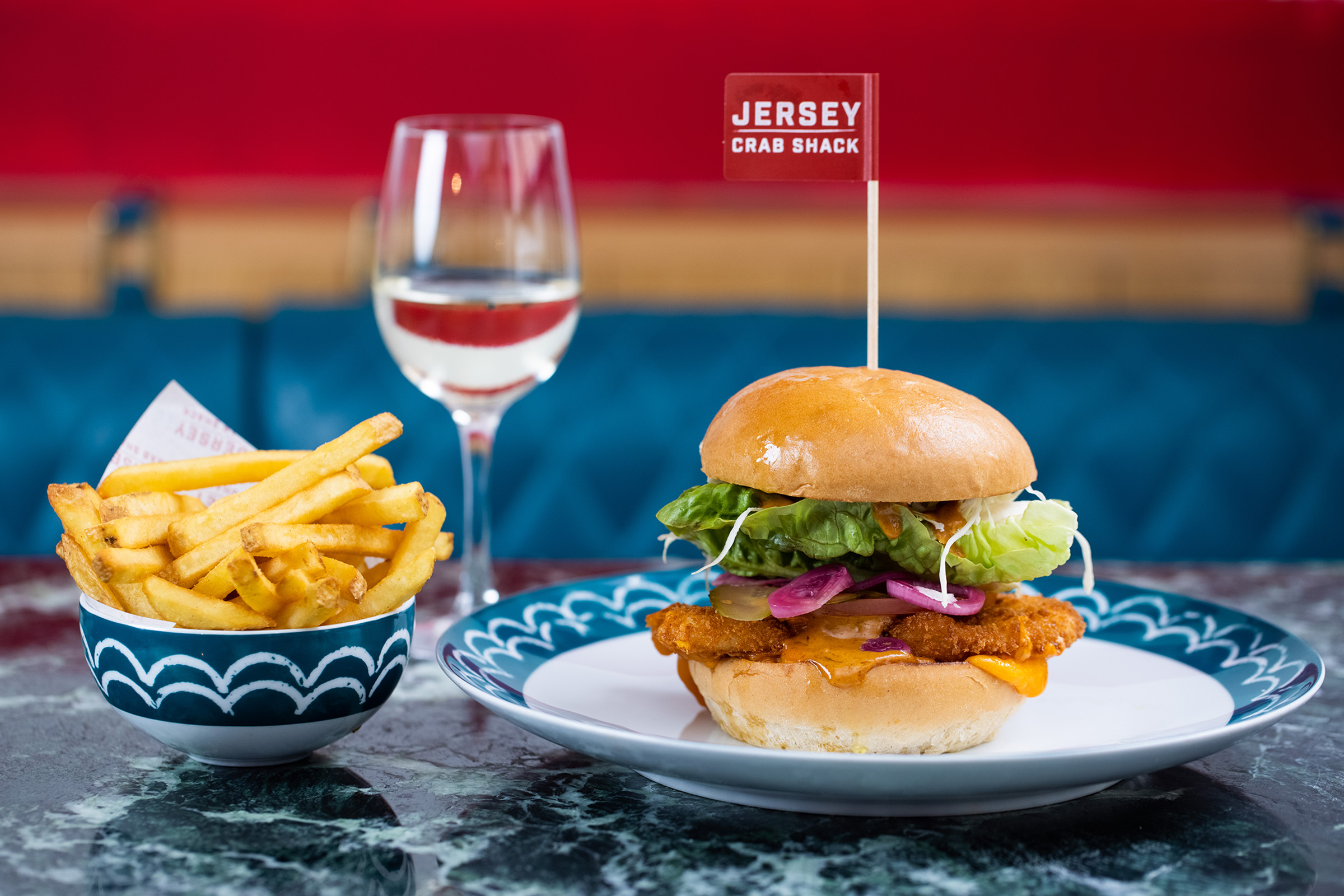 A chicken burger with a Jersey Crab Shack flag