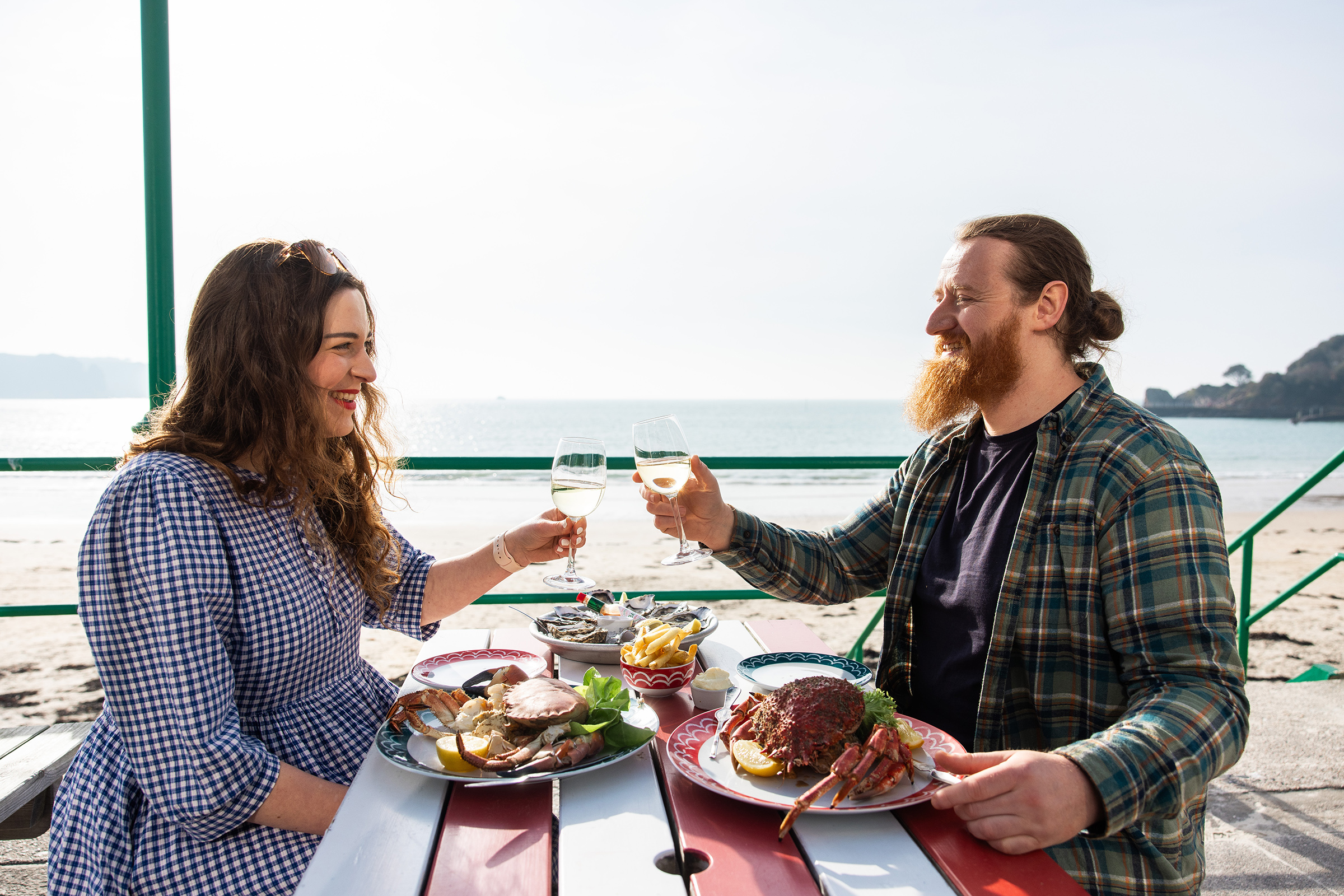 Guests toast on the terrace while eating fresh crab