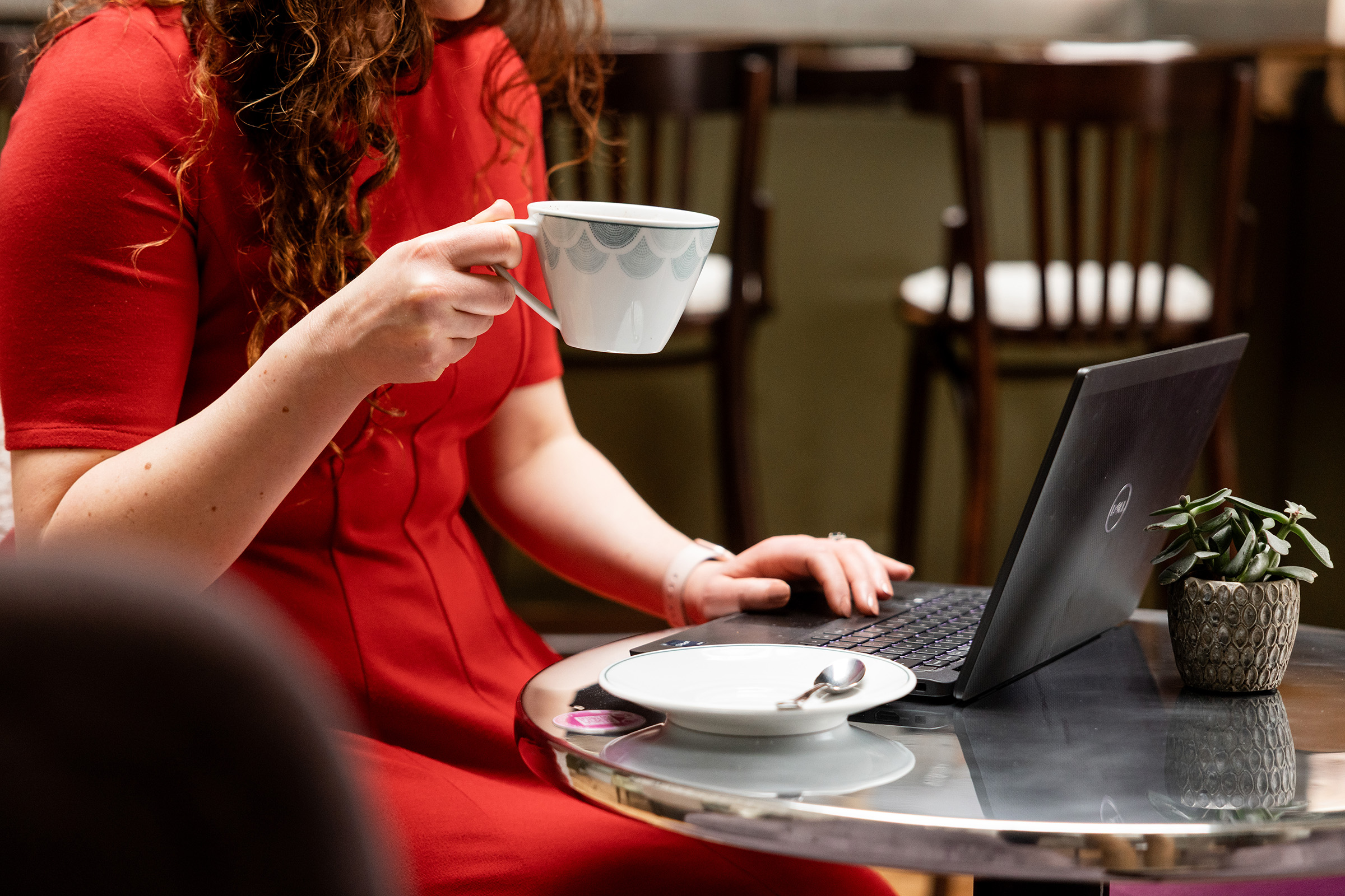 A guest working while drinking coffee