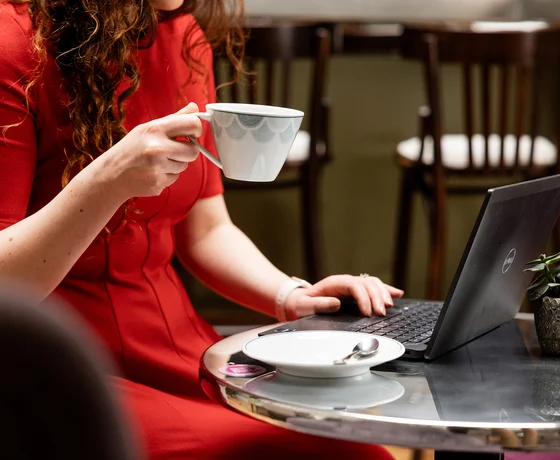 A guest working while drinking coffee
