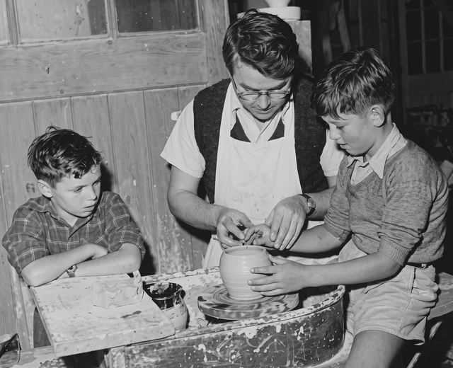 A refined high resolution version of an original 1950s image of children watching ceramic production at Jersey Pottery