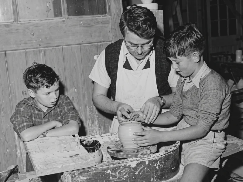 A refined high resolution version of an original 1950s image of children watching ceramic production at Jersey Pottery