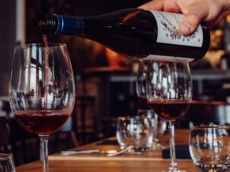 A team member pours wine in The Old Vic